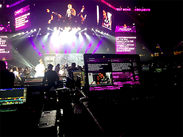 A view of the web browser running the Superdome event display and the display on the 100-foot screens on stage